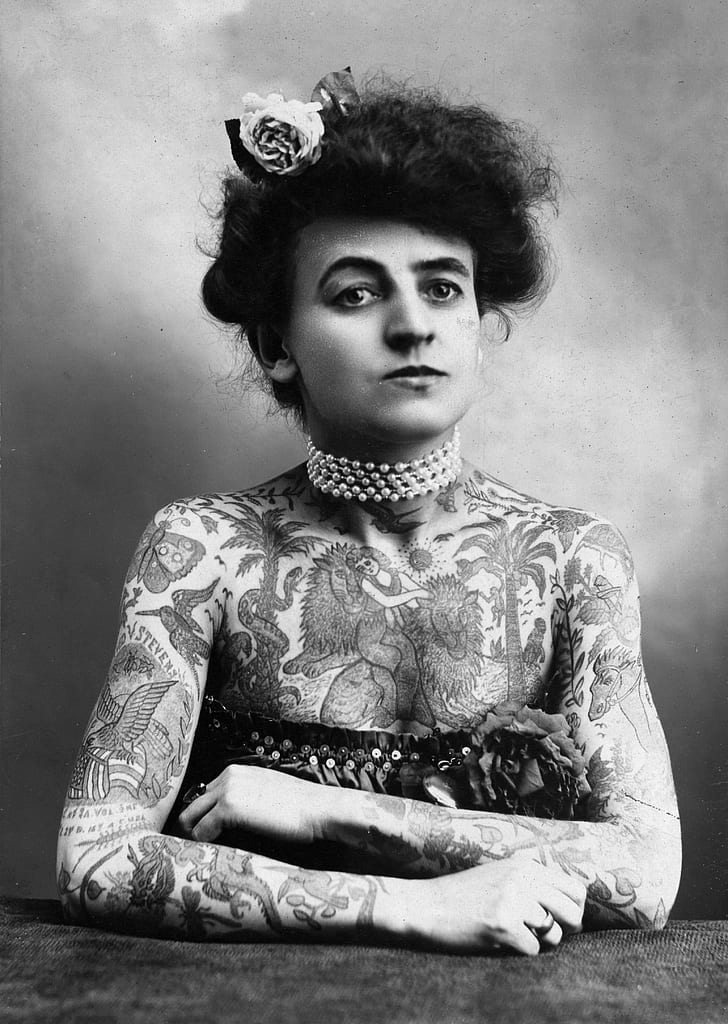 grayscale photograpy of woman covered with tattoo