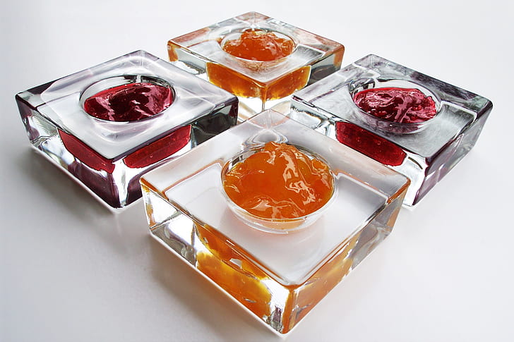 four square clear glass containers filled with substances