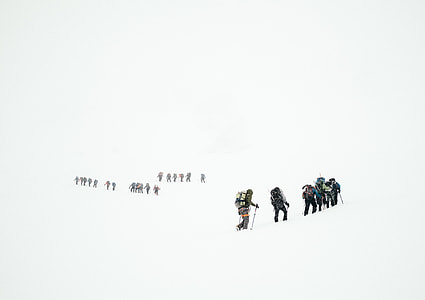 photo of people walking on area field with snow