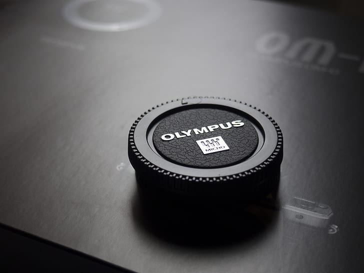 Olympus Camera Lens Cap Placed on Box