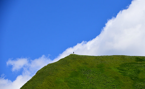 person standing on mountain cliff