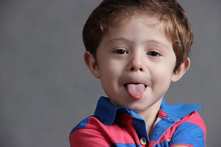 photo of boy sticking tongue out