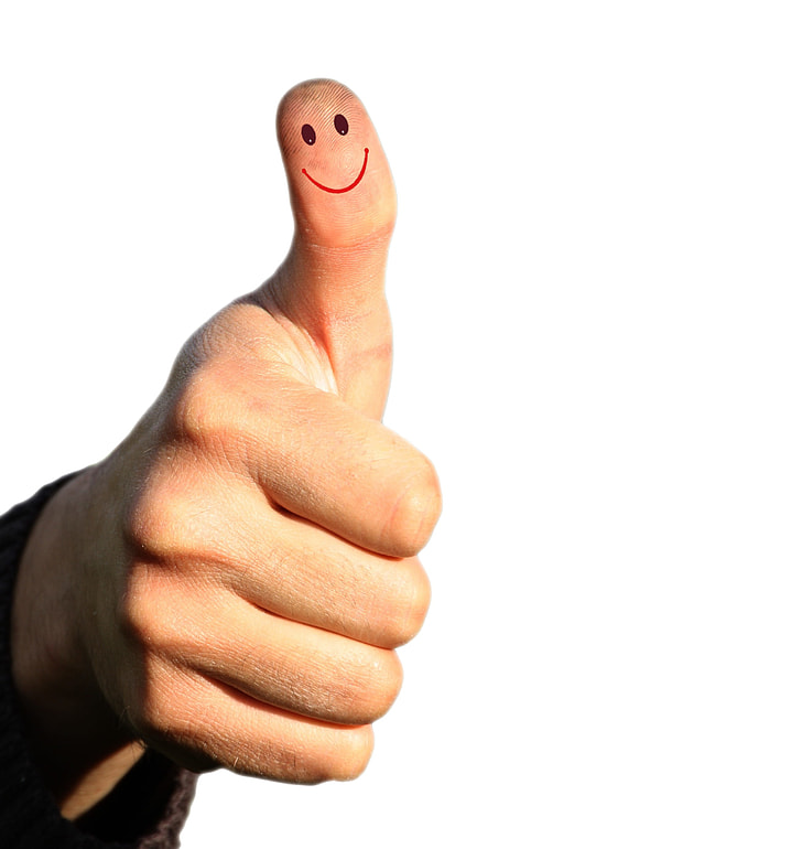 right person's thumb with smiley drawing