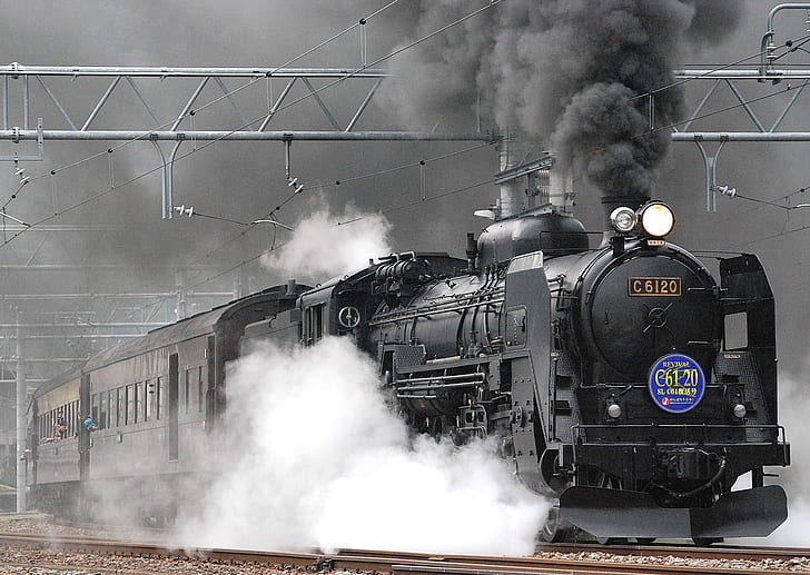 grayscale photograph of train with heavy smoke