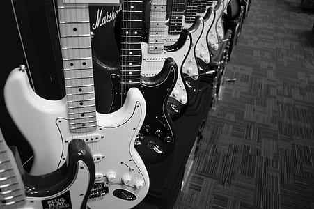 grayscale photo of guitars