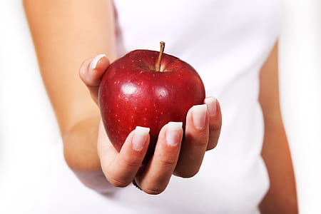 person holding red apple