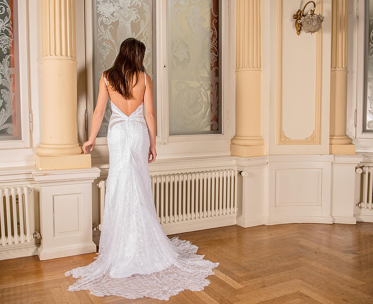 photo of woman in back-less floor length dress