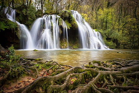 time lapse photo of waterfalls surrounded by trees