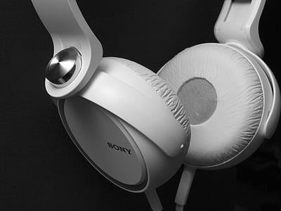 closeup photo of white corded Sony full size headphones
