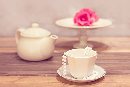 shallow focus photography of white ceramic mug with saucer on table