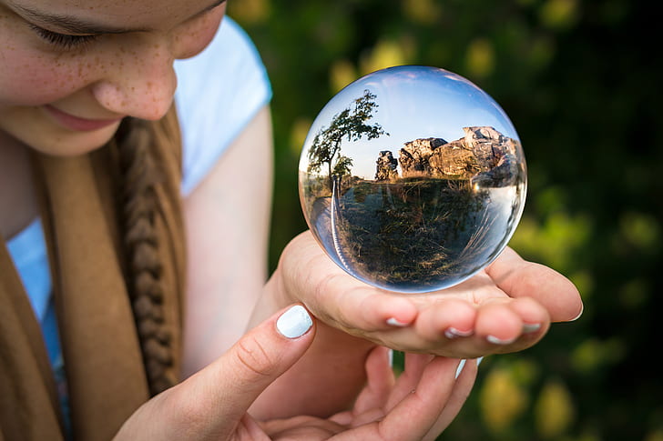 women holding clear glass globe