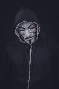 person wearing seafawk mask and black zip-up hoodie