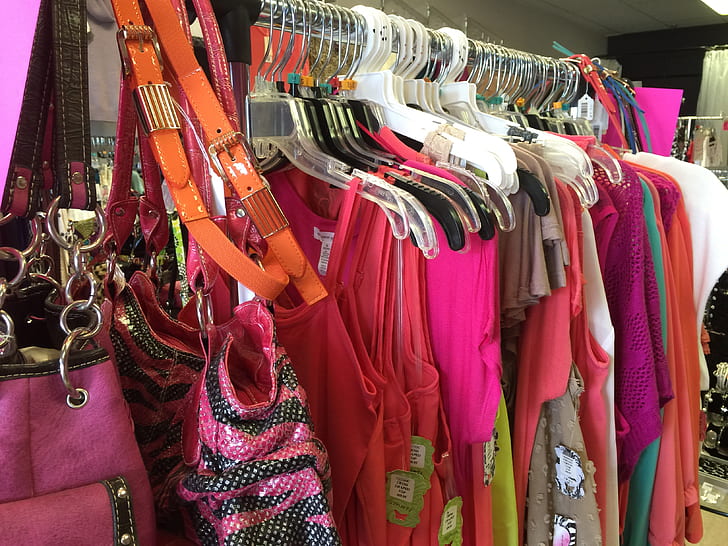 assorted-color dresses hanged on silver clothes rack