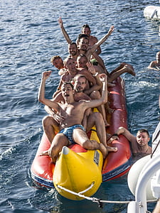 group of men riding banana boat