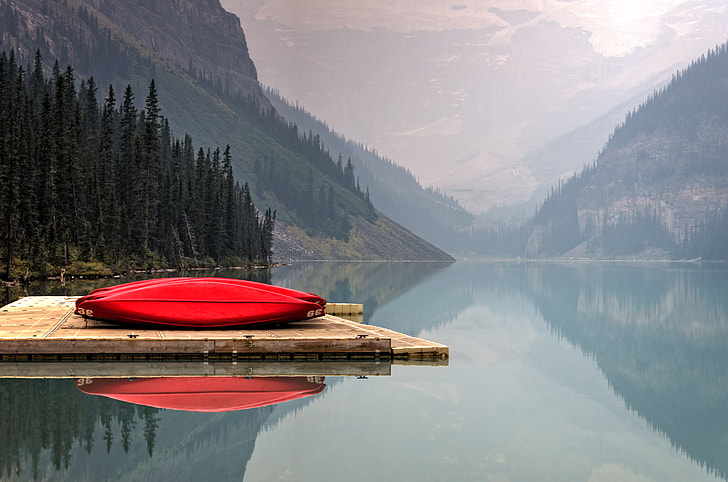 red canoe on brown wooden dock during daytime