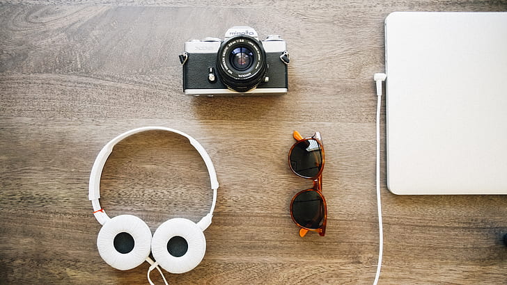 fly lay photography of headphones, MILC, laptop, and wayfarer sunglasses