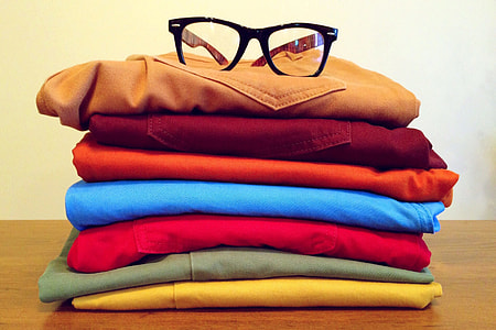 Clothing in pile with reading glasses