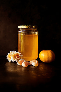 clear glass jar filled with orange fruit citrus