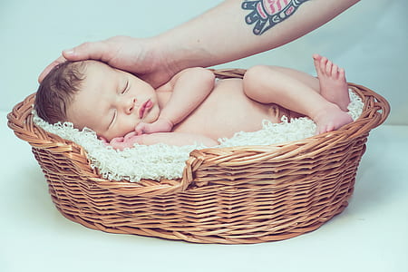baby in brown wicker basket