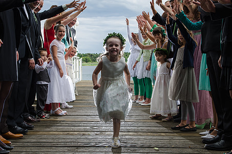girl in white sleeveless dress running on a bridge