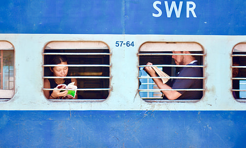 man and woman holding books inside SWR vehicle
