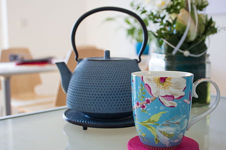 blue and white mug near blue kettle