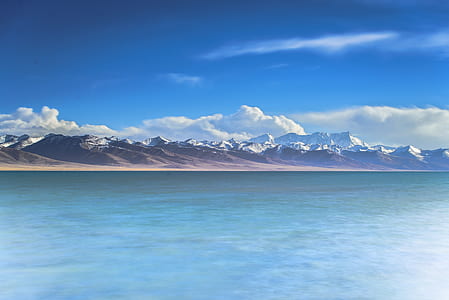 landscape photograph of mountains in front of bodywater