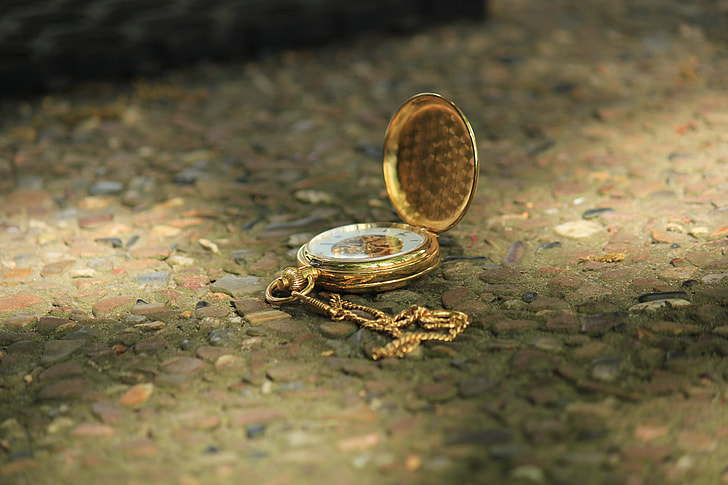 gold-colored pocket watch