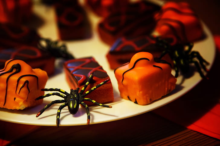 black spider and muffins on white ceramic plate