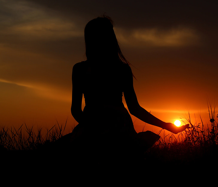 silhouette photograph of woman during sunset
