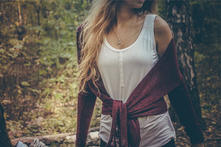 woman wearing white tank top and red sweater on forest