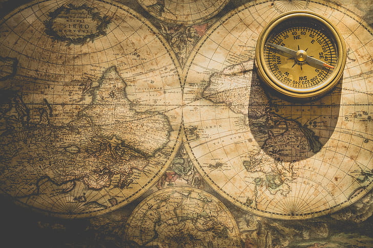photography of world map and compass