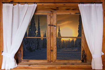 window with white curtains during golden hour
