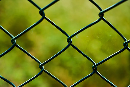 gray steel fence in closeup photography