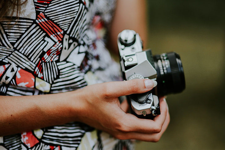 Woman in a dress with a camera
