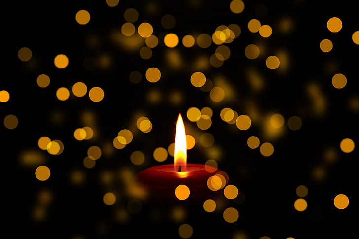 close up photo of lighted red candle bokeh photography