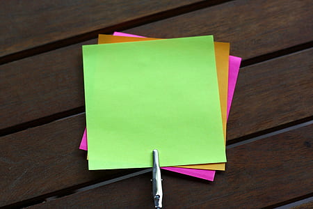 sticky notes on brown wooden surface