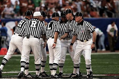 8 Football Referees in the Field