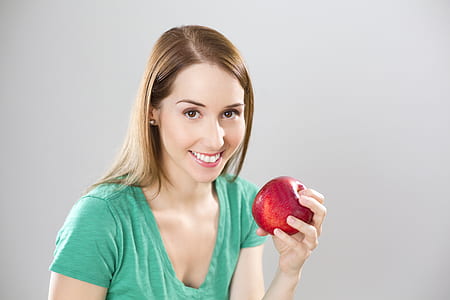 woman holding red apple