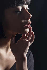 women's black eye lash and red-shade of lipstick