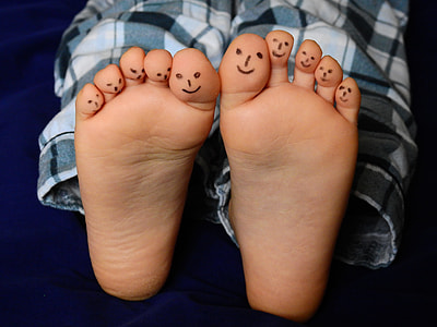 human feet with face drawings
