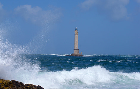 gray lighthouse near body of water