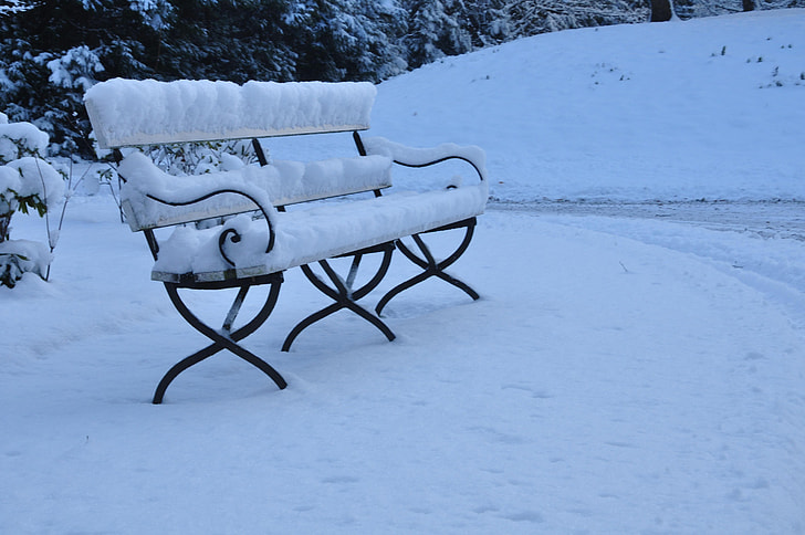 black steel bench with snow on top