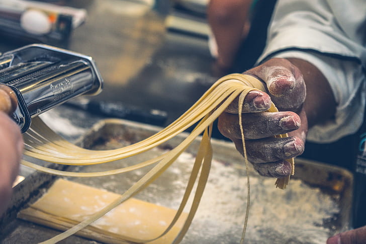 person making pasta