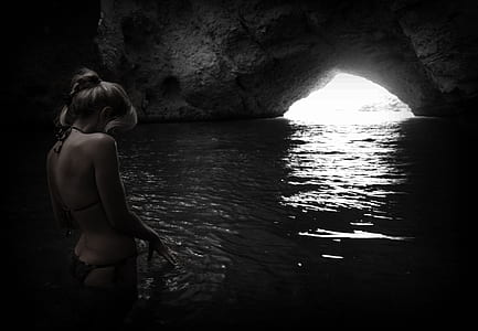 woman in black bikini on cave