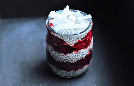 white and red votive candle in close-up photography