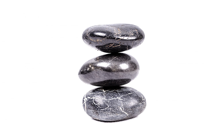 three black stone pebbles