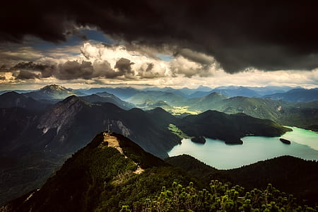 landscape photo of body of water surrounded by mountain