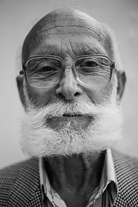 grayscale photography of man wearing eyeglasses