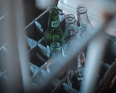 selective focus photography of glass soda bottles